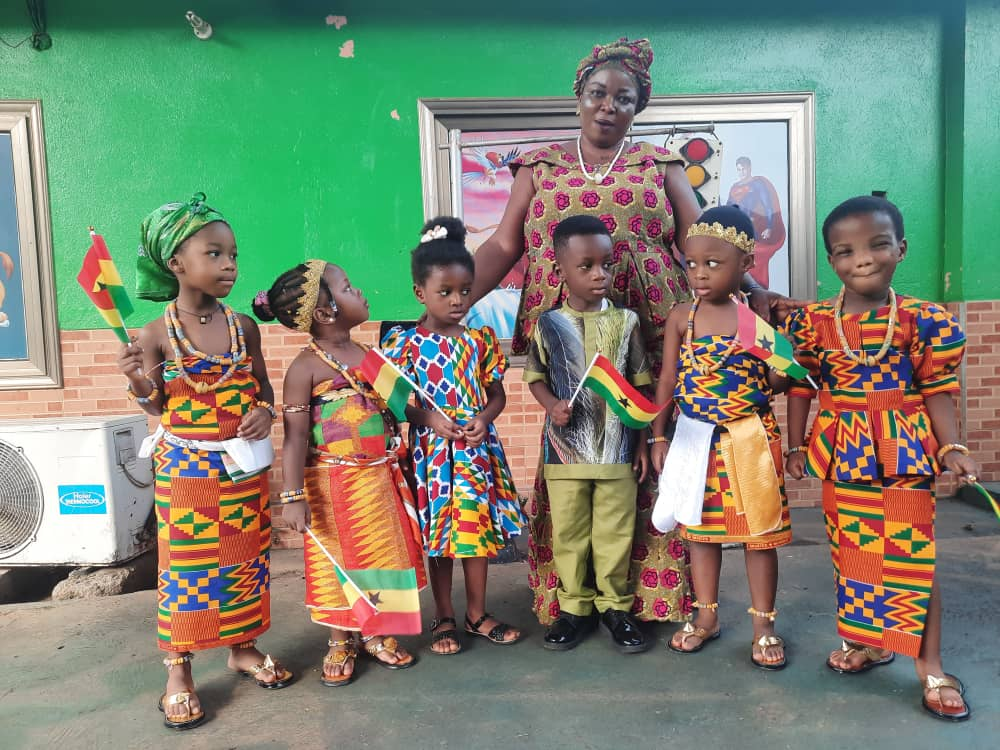 Little ones with our teacher in kente